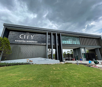 a building with a sign and grass