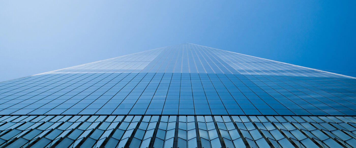 looking up a tall building with many windows